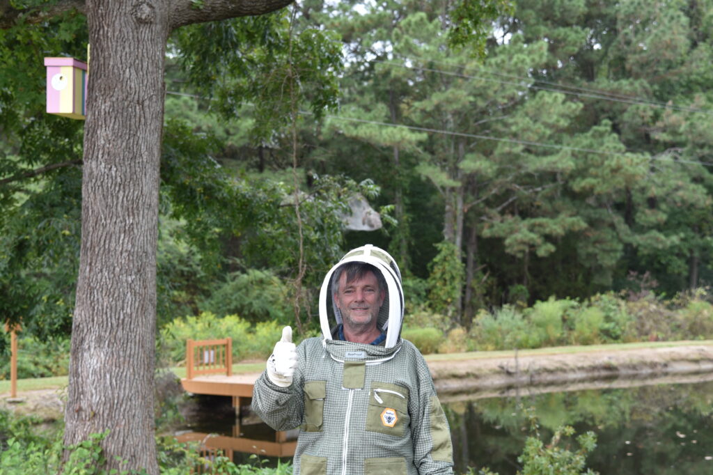 Beekeeper in suit giving thumbs up