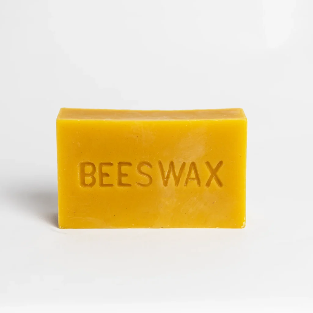 Yellow beeswax block labeled 'BEESWAX'